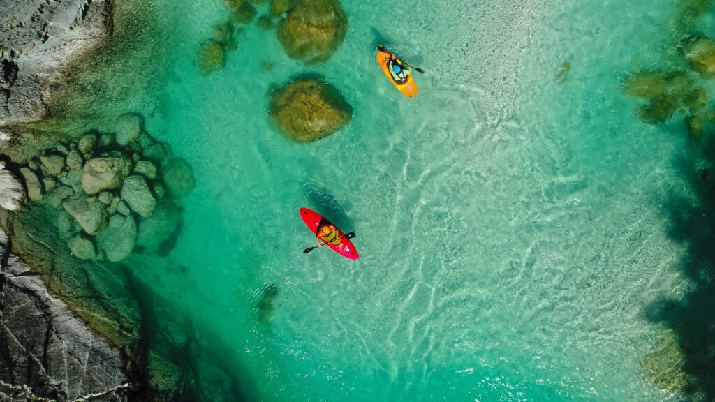 Two kayaks seen from directly above on the emerald water of the Soča river