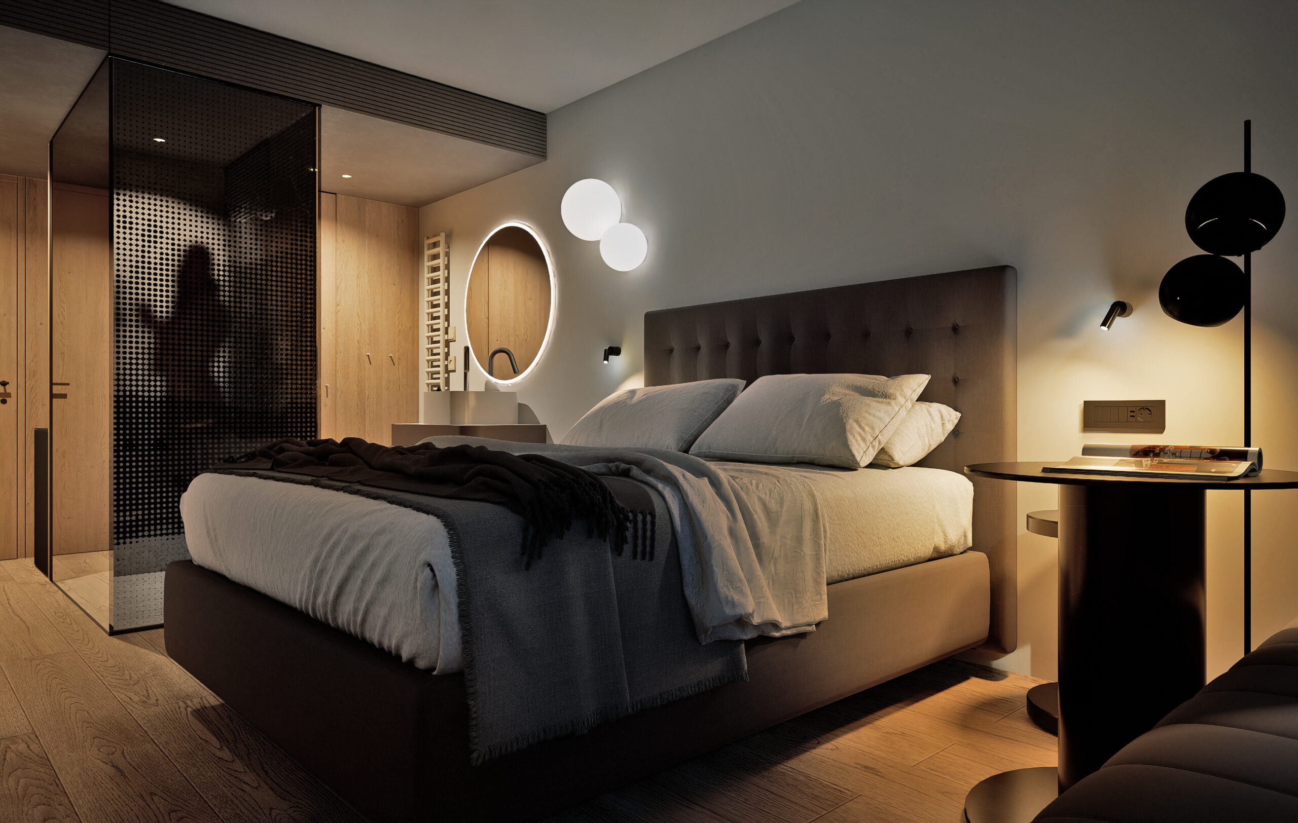 The Planika Room lit in the evening, bedside globe lights on and the glazed bathroom glowing behind